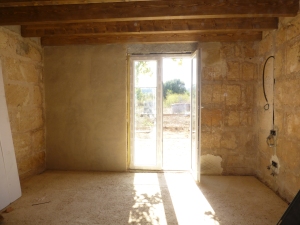 lime plaster wall with window and wooden beams